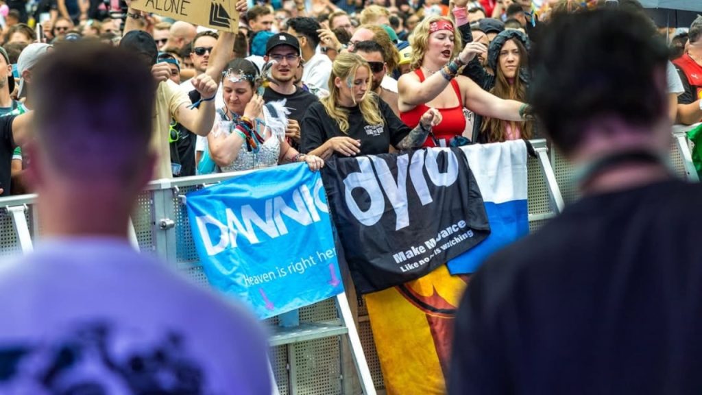 the crowd in tomorrowland waves flags named dannic and dyro
